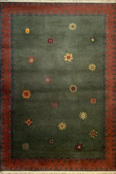 a green rug with red border and colorful flowers on the bottom, in front of a white background