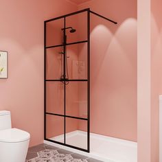 a bathroom with pink walls and a white toilet next to a walk in shower stall