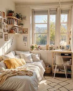 a bed sitting in a bedroom next to a window filled with lots of books and pictures