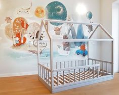 a child's room with a mural on the wall