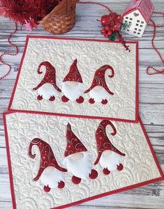 two red and white gnomes placemats on a table