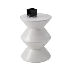 a white table with a black object on top