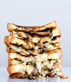 a stack of grilled cheese and mushroom sandwiches