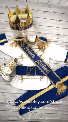 a blue and white uniform with gold trimmings on the chest, two shoes and a crown