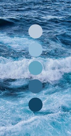 an abstract photo of blue and white circles floating over the ocean