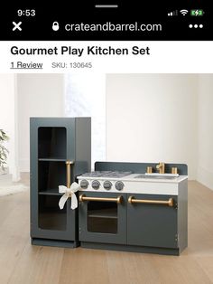 a kitchen set with an oven, stove and cabinets in grey and white color scheme