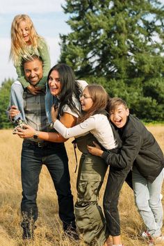 a group of young people standing in a field