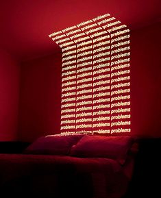 a bed in a room with red lighting on the wall