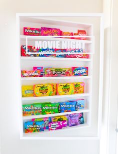 a white shelf filled with candy and snacks