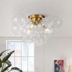 a living room filled with furniture and a chandelier hanging from it's ceiling