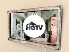 the hgtv logo is reflected in an old window with a white sticker on it