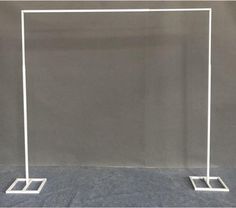 a white metal frame with two square bases