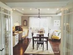 a dining room table and chairs in front of a window