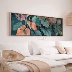 a living room with white couches and large painting on the wall above it's headboard