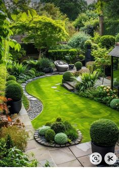 an outdoor garden with green grass and plants in the center, surrounded by trees and bushes