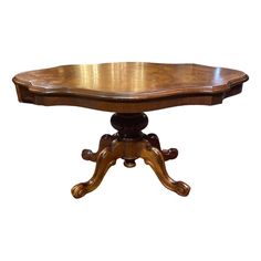 a wooden table with an oval shaped top