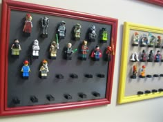 lego minifigures are displayed on the wall next to each other in a red frame