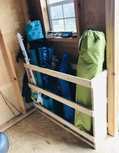 the inside of a small wooden cabin with various items in it and a bag on the floor