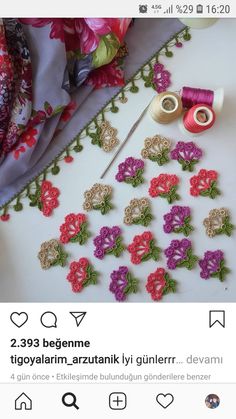 an image of some flowers and thread on a table