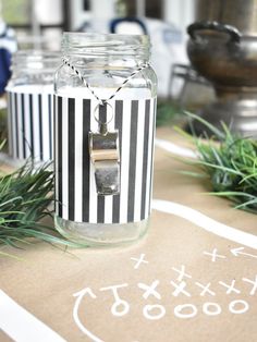 a jar filled with some sort of something on top of a table covered in grass