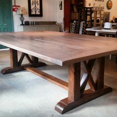 a large wooden table sitting inside of a room