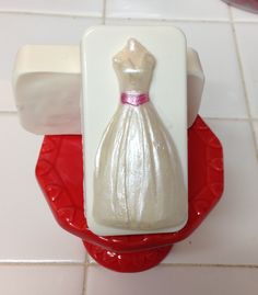 there is a plastic dress on top of a soap dispenser