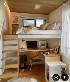 there is a loft bed with stairs to the top and desk below it in this small room