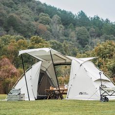 a tent set up in the middle of a field