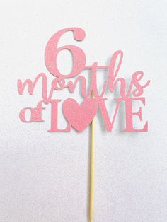 a pink cake topper that says 6 months of love