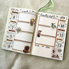 an open planner with coffee cups on it