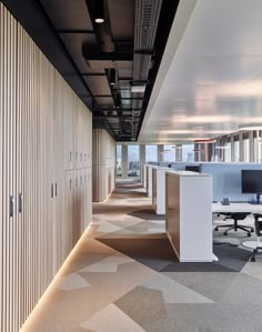 an empty office with cubicles and desks