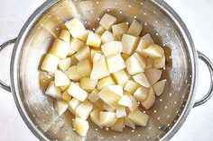 chopped potatoes in a colander on the stove