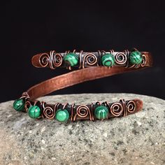 The unique free-form design of this spectacular wrap bracelet draws inspiration from rich Armenian art. Artisans Hasmik and Musheg create this alluring accessory that seamlessly blends copper wires and textured sheets with a captivating antique finish, adorned with enchanting malachite beads. Handmade Copper Bracelet, Wired Jewelry, Malachite Bracelet, Copper Wire Jewelry, Malachite Jewelry, Copper Cuff Bracelet, Copper Sheets, Wire Wrapped Bracelet, Copper Cuff