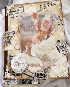 an altered book with paper flowers on it