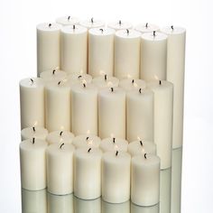 many white candles are lined up together