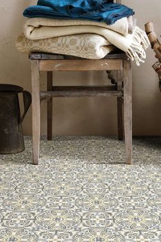 a pile of towels sitting on top of a wooden chair