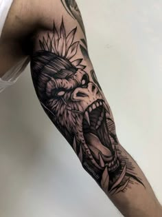 a man's arm with a lion and sunflower tattoo on the left forearm