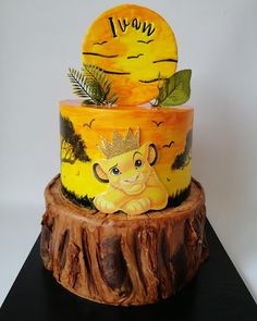 a three tiered cake decorated with an image of a lion sitting on top of a tree stump