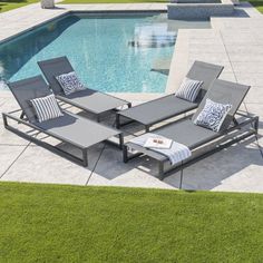 an outdoor lounge set next to a swimming pool