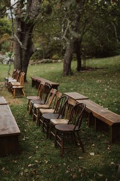 rows of wooden benches and chairs in the grass