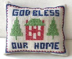 a cross stitch pillow with the words god's blessing our home