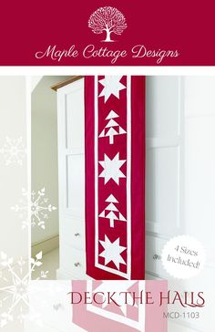 a red and white quilt hanging from the side of a door with snowflakes on it