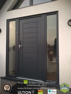 the front door to a home with glass panels and black trim on it's side