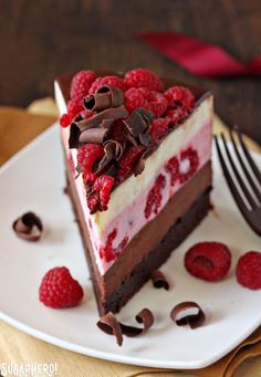 a piece of cake with raspberries and chocolate on top