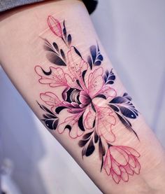 a woman's leg with a flower tattoo on the side of her arm,