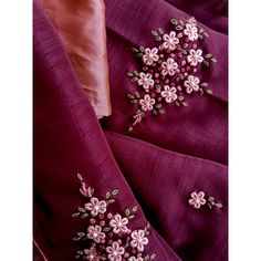 two pieces of purple fabric with pink flowers on them