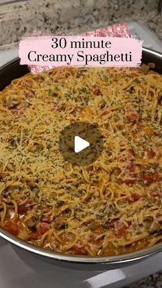 a pan filled with pasta and sauce on top of a stove