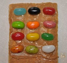 there are many different colored candies on this piece of food that is made to look like an egg carton