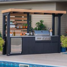 an outdoor bbq grill next to a swimming pool with potted plants on it