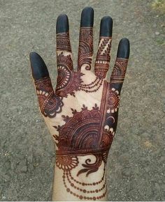 a person's hand with henna on it